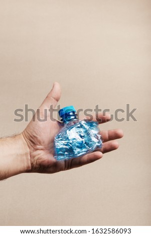 Similar – Image, Stock Photo Male hand holding squashed plastic bottle