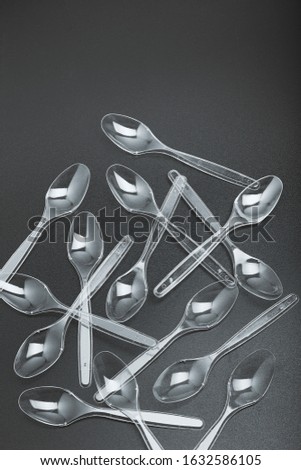 Image, Stock Photo Plastic spoons scattered over black background