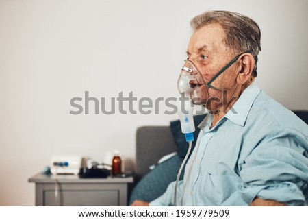 Similar – Image, Stock Photo Senior man inhaling airways and lungs applying medicine. Covid-19 or coronavirus treatment. Man breathing through face mask using nebuliser