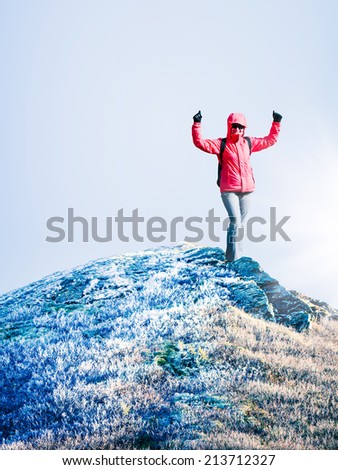 Woman at the top of mountain at cold autumn day. Space for text