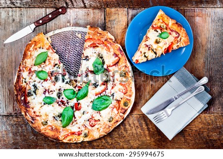 Top shot of homemade pizza on a wooden table