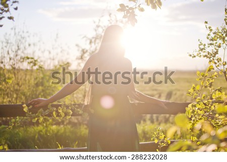 Force is not recognizable on the nature girl with a beautiful sunset