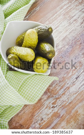 small pickles in white bowl on the table