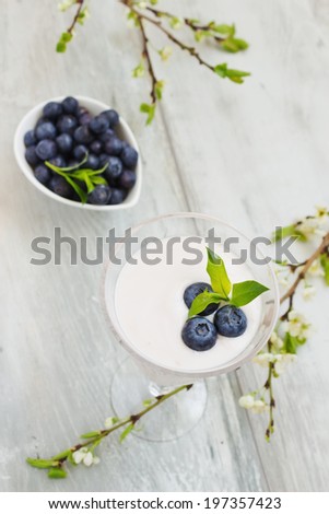 milk shake in a wine glass with fresh blueberries. selective focus