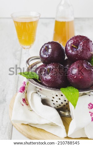 ripe plum and plum juice on the table.selective focus.health and diet food