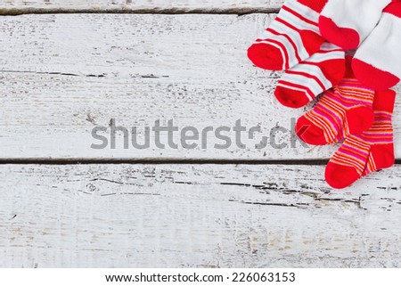 baby red striped socks on a light wooden background. children\'s clothing.copy space for text