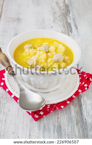 soup with meatballs and rice on the kitchen table. delicious lunch. hearty soup