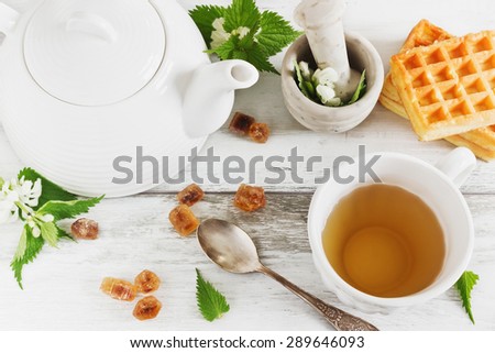 nettle tea. kettle, sugar and fresh nettle branches. health and diet concept
