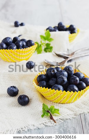 fresh blueberries in paper cups on the table. gifts of summer.  health and diet concept