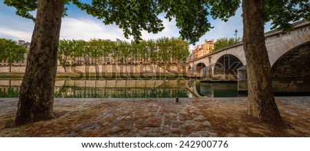 Ile Saint Louis and Pont Marie with the Seine River banks lined with aspen trees on a quiet early morning in the middle of the summer, Paris 4th arrondissement, France.