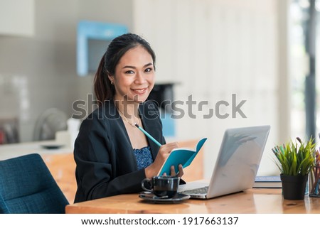 Similar – Image, Stock Photo Thoughtful woman taking notes in notebook in cafe