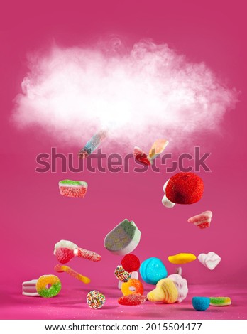 Similar – Image, Stock Photo Many colorful candies fall down in front of a black background