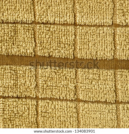 High resolution close up of a beige towel cloth with single darker brown stripe crossing it horizontally.