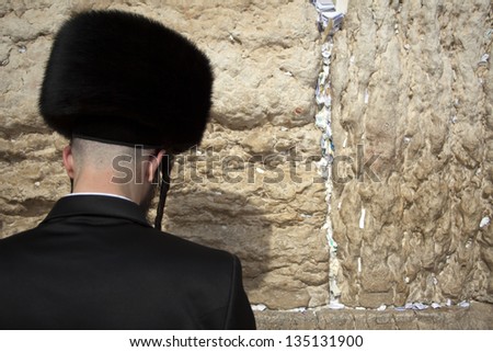 JERUSALEM - MAY 21: An orthodox Jewish senior man pressed in prayer against the wailing wall on May 21 2010 in Jerusalem, Israel