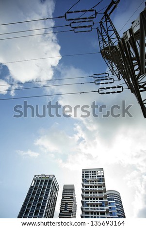 TZAMERET - JUNE 28: High voltage electricity pylon from directly below. A cluster of luxury apartment buildings seen in the background. In Tzameret neighborhood, Israel on June 28, 2011.