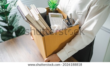 Business woman sending resignation letter and packing Stuff Resign Depress or carrying business cardboard box by desk in office. Change of job or fired from company. Stockfoto © 