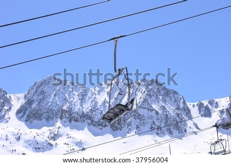 Ski lift chair on snow covered mountain in a ski resort