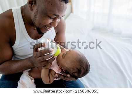 Similar – Image, Stock Photo Single dad feeding his baby who is sat in a high chair