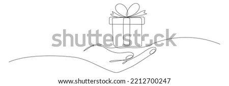 Human hand holding gift box continuous line. One line art drawn surprise. Birthday symbol. Vector isolated on white.