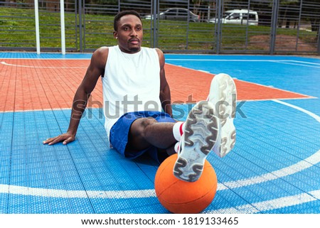 Similar – Image, Stock Photo Black athletic man sitting on lawn and using smartphone