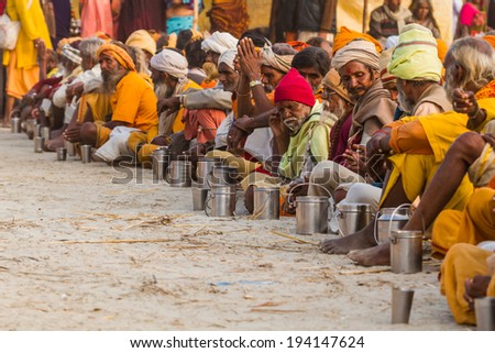 ALLAHABAD, INDIA - FEB 14 - Hindu Sadhus wait for free food distribution during the festival of Kumbha Mela on February 14th 2013 at Allahabad, India.