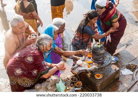 VARANASI, INDIA - FEB 18 - A group of ladies worshiping a Shiva linga in Varanasi on February 18th 2013