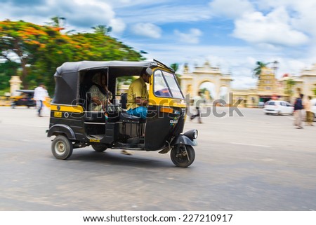 MYSORE, INDIA  JULY 24th  An auto rickshaws driving along the street in Mysore, South India on 24th July 2010.