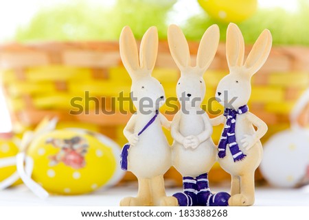 basket with easter eggs and easter rabbits isolated on white background