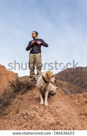 A man outdoors, walking in the mountains and enjoy the sights