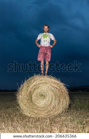 Man jumping on a hay field