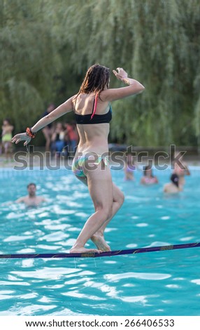 People walk on the sling over the water