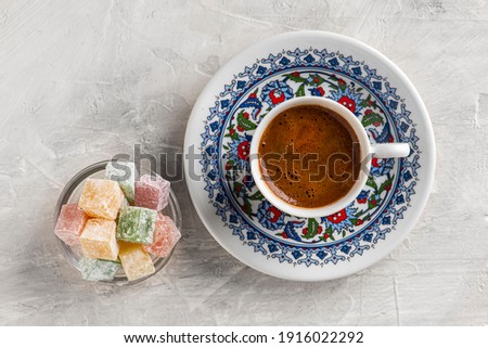 Turkish Coffee with traditional porcelain cup. Coffee presentation with Turkish delight. Sparkling Turkish Coffee.
