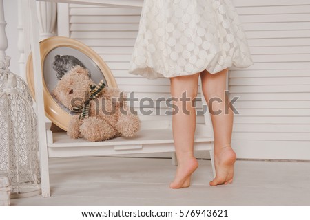 Barefoot girl standing on haystacks