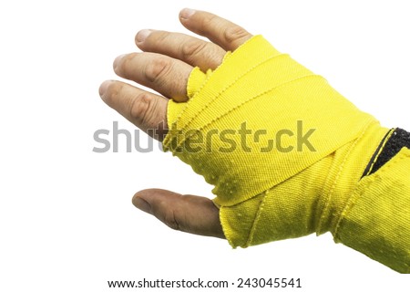 A left hand wrapped in a yellow boxing wrap isolated on a white background.