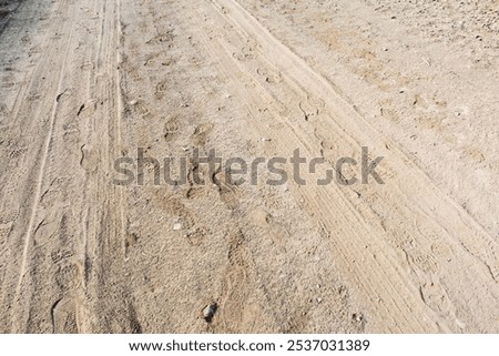 Similar – Image, Stock Photo Footprints and vehicle tracks on a road in the middle of the snowy forest / winter / slush