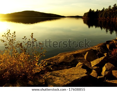 Dramatic sunset at lake. Autumn, October. Algonquin Provincial Park, Ontario, Canada.
