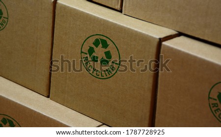 Recycling stamp printed on cardboard box. Recycle symbol, arrows, recyclable materials, environmental protection and earth safe concept.