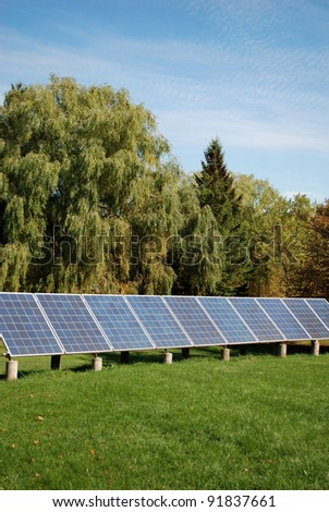 Sun energy batteries on green meadow / Solar Battery