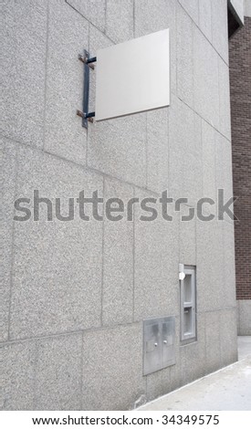 blank white sign on a stone wall