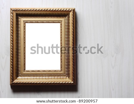 Image of golden art frame on the wall in dramatic light