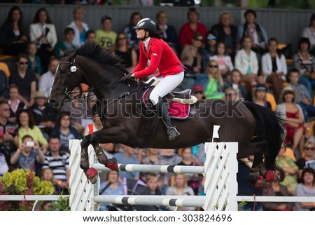 RIGA, LATVIA - Aug  2: Rider Linnea HJALMARSDOTTER (SWE) with horse AUTOGRAF (96) jumps over obstacle at FEI World Cup Qualifying competition CSI2*-W on August 2, 2015 in Riga