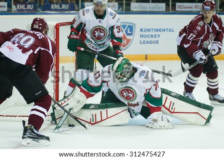 RIGA, LATVIA - AUGUST 25: Goaltender of Ak Bars Emil Garipov (77) saves the goal  in KHL game between Dinamo Riga and Ak Bars played on AUGUST 25, 2015 in Arena Riga