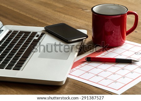 Working with the laptop and organizing monthly activities and appointments in the calendar