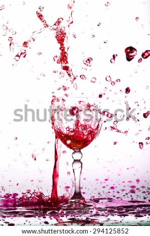 red wine splash in the glass on white background? water drop splash on white background