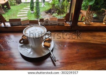 white cup of hot coffee on wooden in coffee shop, white cup of hot coffee on natural green background