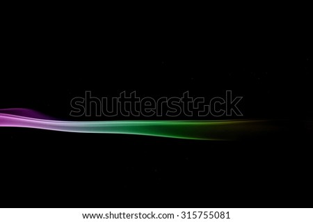 Abstract colorful smoke on black background, color background,colorful ink background,Violet and Green and Orange smoke,Movement of smoke