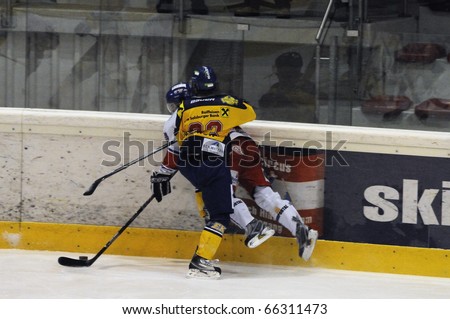 ZELL AM SEE, AUSTRIA - NOVEMBER 30: Austrian National League. Graz player gets hit. Game EK Zell am See vs. ATSE Graz (Result 0-4) on November 30, 2010, at hockey rink of Zell am See