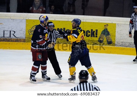 ZELL AM SEE, AUSTRIA - DECEMBER 7: Austrian National League. Referees stopping fight. Game EK Zell am See vs. Red Bulls Salzburg (Result 4-6) on December 7, 2010, at hockey rink of Zell am See