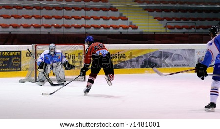 ZELL AM SEE, AUSTRIA - FEB 13: Salzburg hockey League. Niki Lang scores on a breakaway. Game SV Schuttdorf vs HCS Morzg  (Result 9-3) on February 13, 2011 at the hockey rink of Zell am See