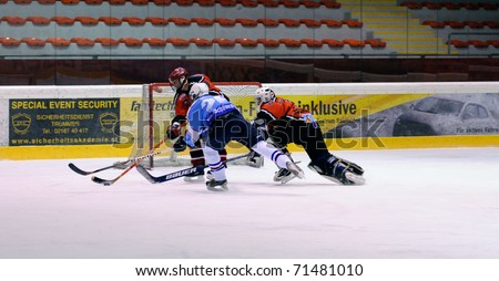 ZELL AM SEE, AUSTRIA - FEB 13: Salzburg hockey League. Goalie Hochwimmer dives to the net to save the puck. Game SV Schuttdorf vs HCS Morzg (9-3) on February 13, 2011 at the hockey rink Zell am See